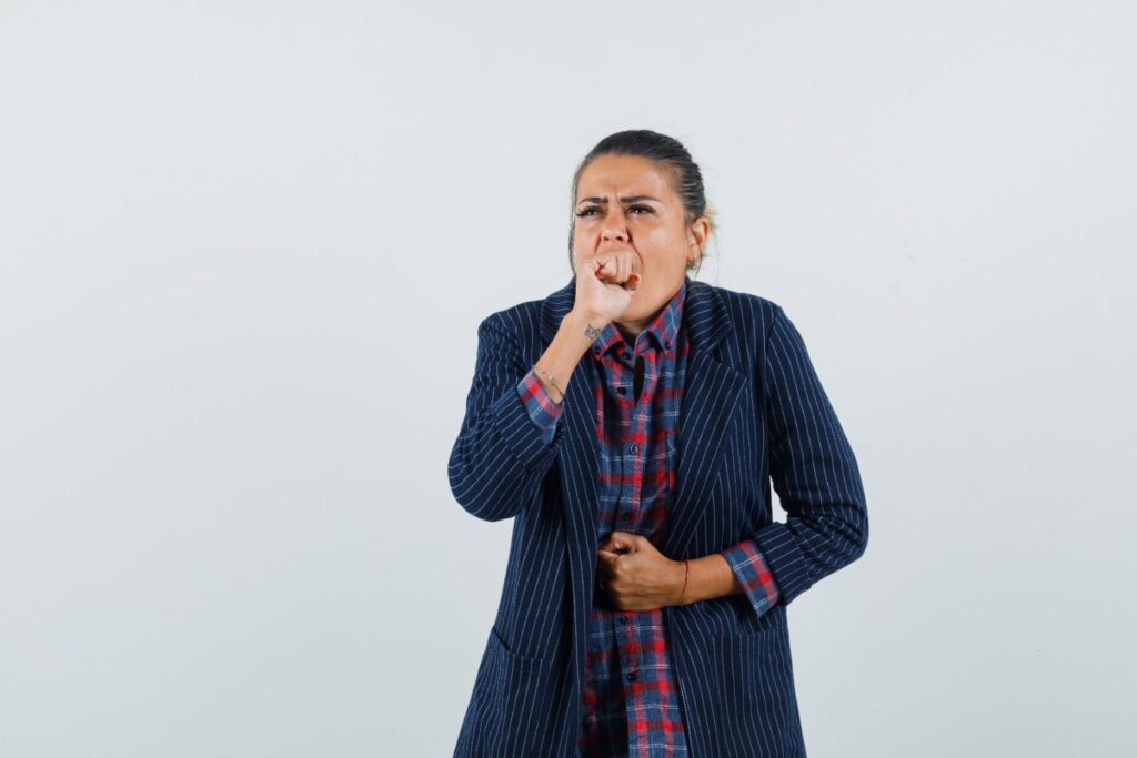 Woman experiencing anxiety nausea and stomach discomfort caused by stress