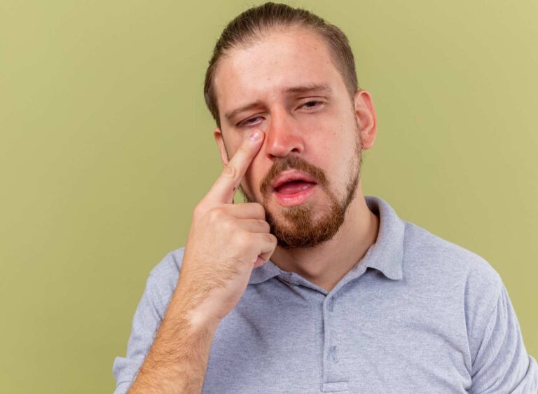 Person experiencing pain in the inner and outer corner of the eye with redness and irritation