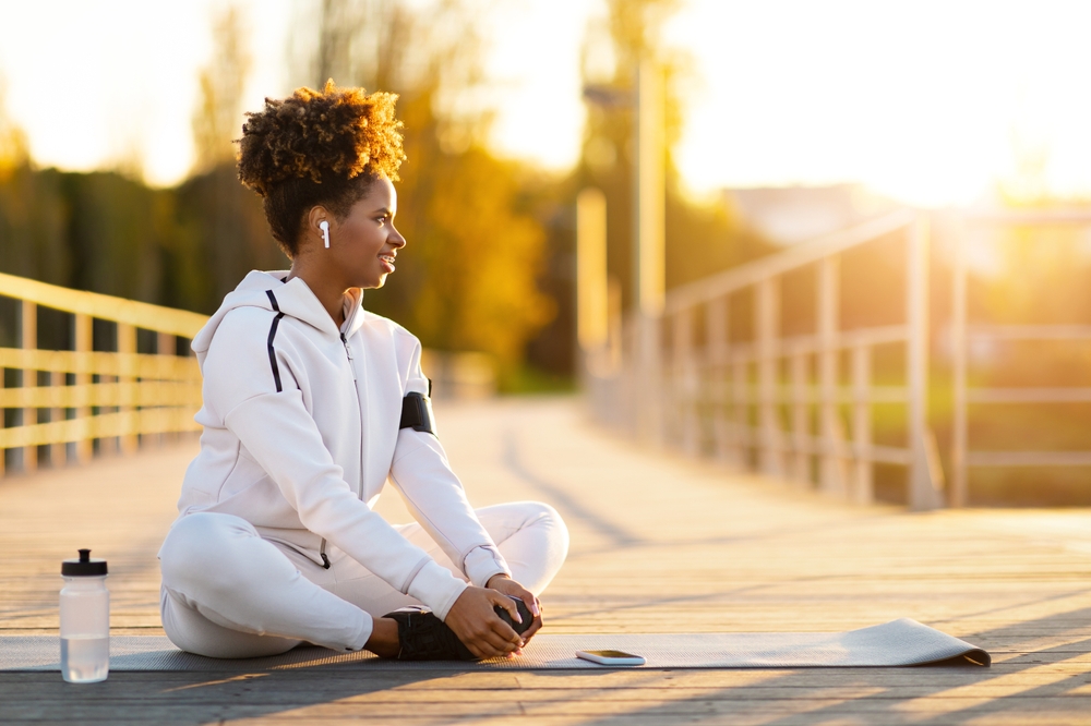 Woman performing a seated butterfly stretch to improve hip flexibility and stretch the inner thigh muscles with proper form.