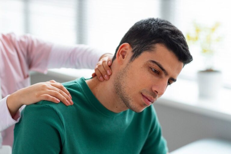 Healthcare professional examining a patient with collarbone pain near the neck and shoulder.