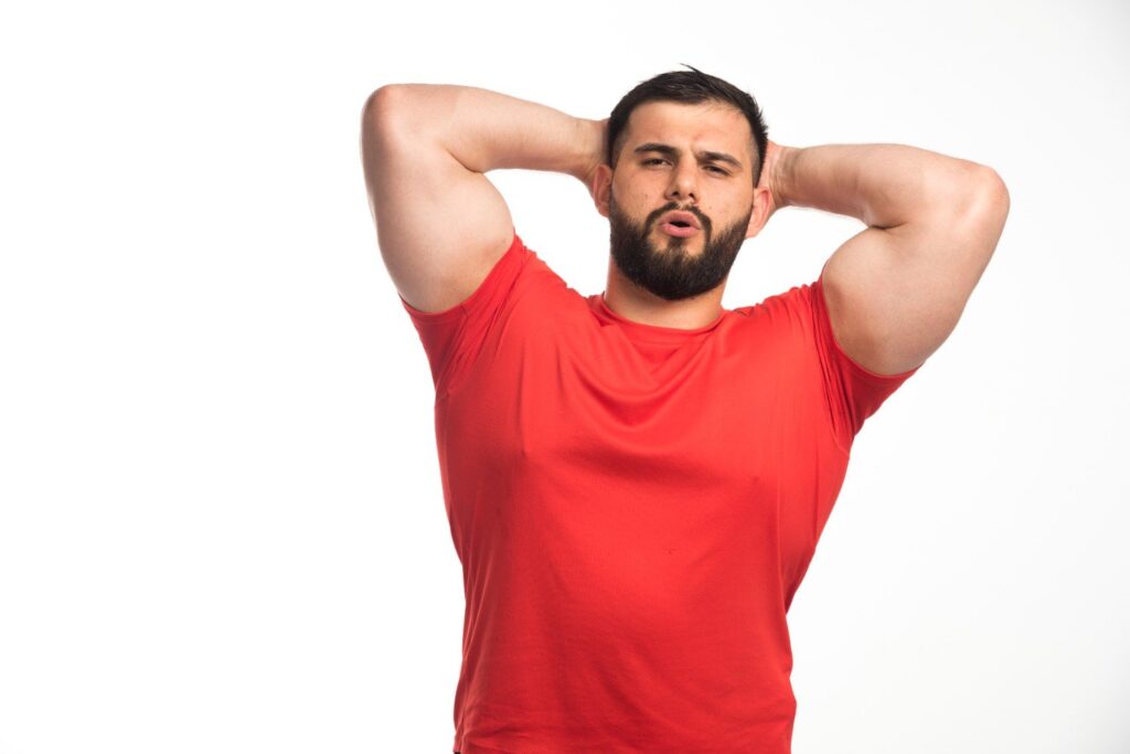 Man showing underarm area and armpit fat