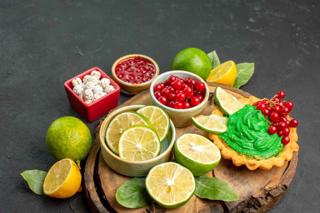 Fresh sour fruits including lemons, limes and red currants