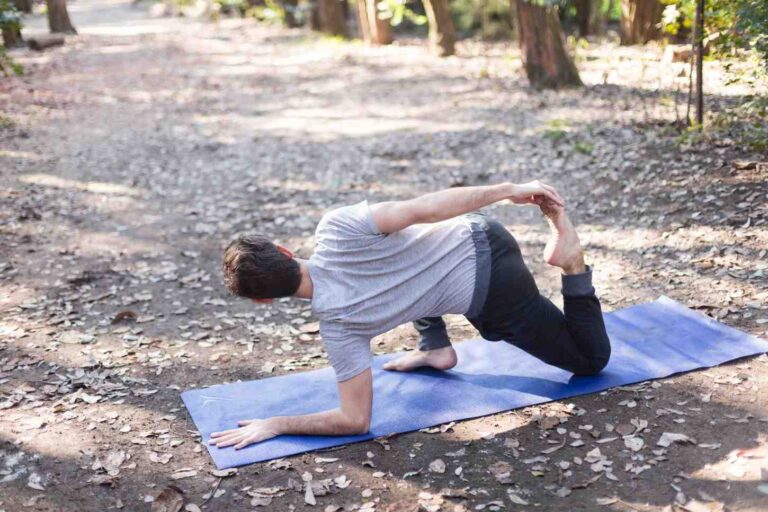 Man performing a thoracic mobility exercise outdoors