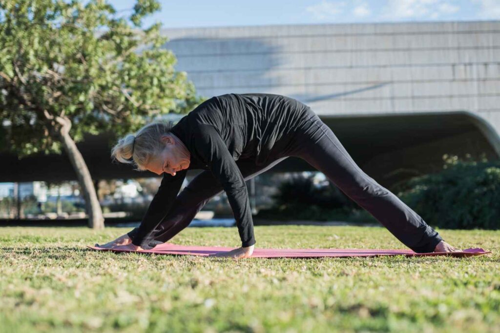 Woman performing an upper back mobility exercise on an exercise mat